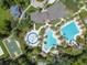 An aerial view of the community center with multiple pools, a playground, and a basketball court at 2544 Rosehaven Dr, Wesley Chapel, FL 33544