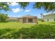 Large backyard featuring a screened patio and green grass creates a perfect outdoor retreat at 2544 Rosehaven Dr, Wesley Chapel, FL 33544