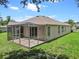 A partially shaded back patio provides room for relaxing or entertaining at 2544 Rosehaven Dr, Wesley Chapel, FL 33544