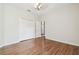 Bedroom with hardwood floors features a closet with double doors and access to the hallway at 2544 Rosehaven Dr, Wesley Chapel, FL 33544