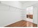 Spacious walk-in closet with metal shelves offering ample storage space, adjacent to the bathroom at 2544 Rosehaven Dr, Wesley Chapel, FL 33544