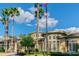 Exterior view of the clubhouse with grand windows, palm trees, and flags flying at 2544 Rosehaven Dr, Wesley Chapel, FL 33544