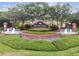 A beautifully landscaped community entrance with a brick sign and fountains welcomes residents and visitors to Seven Oaks at 2544 Rosehaven Dr, Wesley Chapel, FL 33544