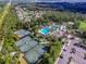 Aerial view of community amenities with tennis courts and a large pool surrounded by palm trees at 2544 Rosehaven Dr, Wesley Chapel, FL 33544