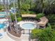 Overhead view of community hot tub area with lounge chairs and cabanas for ultimate relaxation at 2544 Rosehaven Dr, Wesley Chapel, FL 33544
