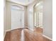 Front entryway has hardwood floors, a white front door, and entry to hallway at 2544 Rosehaven Dr, Wesley Chapel, FL 33544