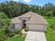 Charming home with manicured landscaping, inviting curb appeal, and a two-car garage at 2544 Rosehaven Dr, Wesley Chapel, FL 33544