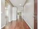 Hallway with hardwood floors leading from the front door towards living areas at 2544 Rosehaven Dr, Wesley Chapel, FL 33544