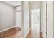 Hallway with hardwood floors leads to a bedroom, with entry to front door visible at 2544 Rosehaven Dr, Wesley Chapel, FL 33544
