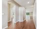 Hallway with wood floors, arched doorways, and natural light extending to the living area at 2544 Rosehaven Dr, Wesley Chapel, FL 33544
