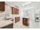 Clean kitchen with tile floors, stainless steel sink and view of the laundry room at 2544 Rosehaven Dr, Wesley Chapel, FL 33544