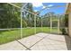 Spacious screened lanai with tiled floor, ideal for outdoor lounging and entertaining at 2544 Rosehaven Dr, Wesley Chapel, FL 33544