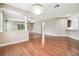 An airy open-concept living space featuring hardwood floors, a chandelier, and view of the kitchen at 2544 Rosehaven Dr, Wesley Chapel, FL 33544
