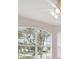 Bright living room with large windows and views of the outdoors, with a ceiling fan at 2544 Rosehaven Dr, Wesley Chapel, FL 33544