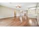 A bright open-concept floorplan featuring hardwood floors, neutral walls, and view of the kitchen at 2544 Rosehaven Dr, Wesley Chapel, FL 33544