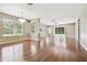 Bright, open-concept living room featuring hardwood floors, lots of natural light, and elegant chandelier at 2544 Rosehaven Dr, Wesley Chapel, FL 33544