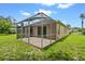 Covered patio with screen offers a relaxing outdoor space, seamlessly blending indoor/outdoor living at 2544 Rosehaven Dr, Wesley Chapel, FL 33544