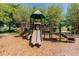 A playground with multiple slides and platforms on a wood chip surface at 2544 Rosehaven Dr, Wesley Chapel, FL 33544