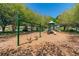 A playground featuring swings and slides, set on a wood chip surface at 2544 Rosehaven Dr, Wesley Chapel, FL 33544