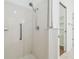 Tiled shower with updated showerhead and convenient grab bar, creating a safe bathing experience at 2544 Rosehaven Dr, Wesley Chapel, FL 33544