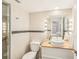 Modern bathroom featuring stylish vanity lighting, updated shower, and neutral stone tile at 2896 Grand Cayman St, Sarasota, FL 34231