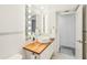 Stylish bathroom featuring a floating vanity, a vessel sink, a lighted mirror, and unique wall textures at 2896 Grand Cayman St, Sarasota, FL 34231