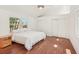 This bedroom boasts wood floors, a ceiling fan, a window, and a double-door closet at 2896 Grand Cayman St, Sarasota, FL 34231