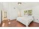 This bedroom features wood floors, a ceiling fan, a high ceiling, and a window at 2896 Grand Cayman St, Sarasota, FL 34231
