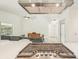 Kitchen area with an island and stainless steel appliances leading to living room with gray sofa and ceiling fan at 2896 Grand Cayman St, Sarasota, FL 34231