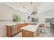 Kitchen with stainless steel appliances, white cabinets, track lighting, and breakfast bar with seating at 2896 Grand Cayman St, Sarasota, FL 34231