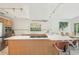 Kitchen with a modern island, stainless steel appliances, white cabinets, track lighting, and breakfast bar at 2896 Grand Cayman St, Sarasota, FL 34231
