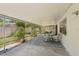 Relax on this covered patio with outdoor seating and a view of the backyard at 2896 Grand Cayman St, Sarasota, FL 34231
