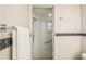 This remodeled shower features glass doors, stone accents, and tiled walls at 2896 Grand Cayman St, Sarasota, FL 34231