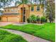 Beautiful home with lush front lawn and mature palm tree at 29916 Cedar Waxwing Dr, Wesley Chapel, FL 33545