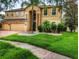 Beautiful home with lush front lawn and mature palm tree at 29916 Cedar Waxwing Dr, Wesley Chapel, FL 33545