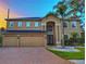 Two-story home boasting a three-car garage and manicured landscaping at 29916 Cedar Waxwing Dr, Wesley Chapel, FL 33545