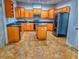 Eat-in kitchen featuring granite countertops, wood cabinetry, and stainless steel appliances at 29916 Cedar Waxwing Dr, Wesley Chapel, FL 33545