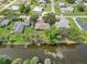 Aerial view of the property with a waterfront backyard and docks at 3156 Depew Ave, Port Charlotte, FL 33952