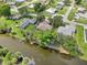 Aerial view of home, showing proximity to canal, neighboring properties, and mature trees at 3156 Depew Ave, Port Charlotte, FL 33952