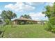 Large backyard with a screened porch, mature landscaping, and plenty of room to enjoy at 3156 Depew Ave, Port Charlotte, FL 33952