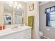 This bathroom features a single sink vanity, tile flooring, a shower-tub combination, a window, and neutral colored walls at 3156 Depew Ave, Port Charlotte, FL 33952