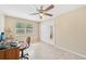 A home office with a ceiling fan, two windows, tile flooring, a closet with mirrored doors, and neutral walls at 3156 Depew Ave, Port Charlotte, FL 33952