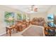 Cozy living room featuring comfortable seating, large windows, ceiling fan, and tile flooring at 3156 Depew Ave, Port Charlotte, FL 33952