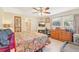A cozy main bedroom features a ceiling fan, neutral walls, a window, tile flooring, a comfortable bed, and a fireplace at 3156 Depew Ave, Port Charlotte, FL 33952
