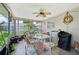Cozy screened-in porch with ceiling fan, dining set, and outdoor living space at 3156 Depew Ave, Port Charlotte, FL 33952
