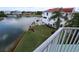 Picture of fenced yard features lush green grass, mature palm trees, and stunning waterfront views at 3402 Amberjack Dr, Hernando Beach, FL 34607