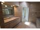 Tiled bathroom featuring a long vanity with double sinks and a walk in shower at 3402 Amberjack Dr, Hernando Beach, FL 34607