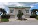 Stylish two-story home featuring a green roof, twin garages, and mature palm trees at 3402 Amberjack Dr, Hernando Beach, FL 34607