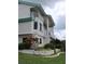 Attractive home with balconies, white railings, and lush landscaping at 3402 Amberjack Dr, Hernando Beach, FL 34607
