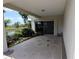 Covered patio overlooking a serene pond, surrounded by lush landscaping at 3402 Amberjack Dr, Hernando Beach, FL 34607